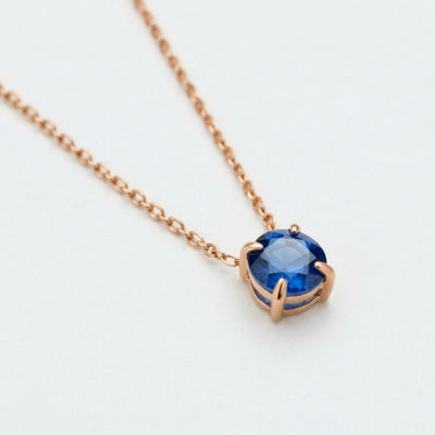 sapphire birthstone necklace in rose gold finish — side view