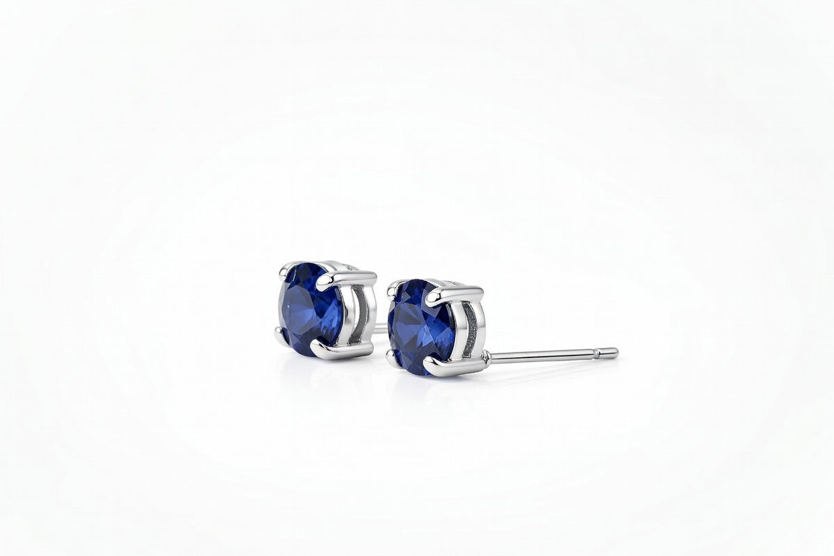 sapphire birthstone stud earrings in white gold finish — side view
