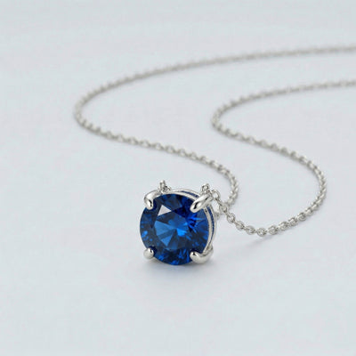 sapphire birthstone necklace in white gold finish — side view