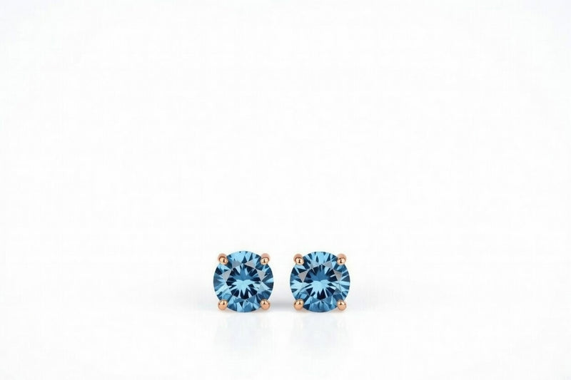 blue topaz birthstone stud earrings in rose gold finish — front view