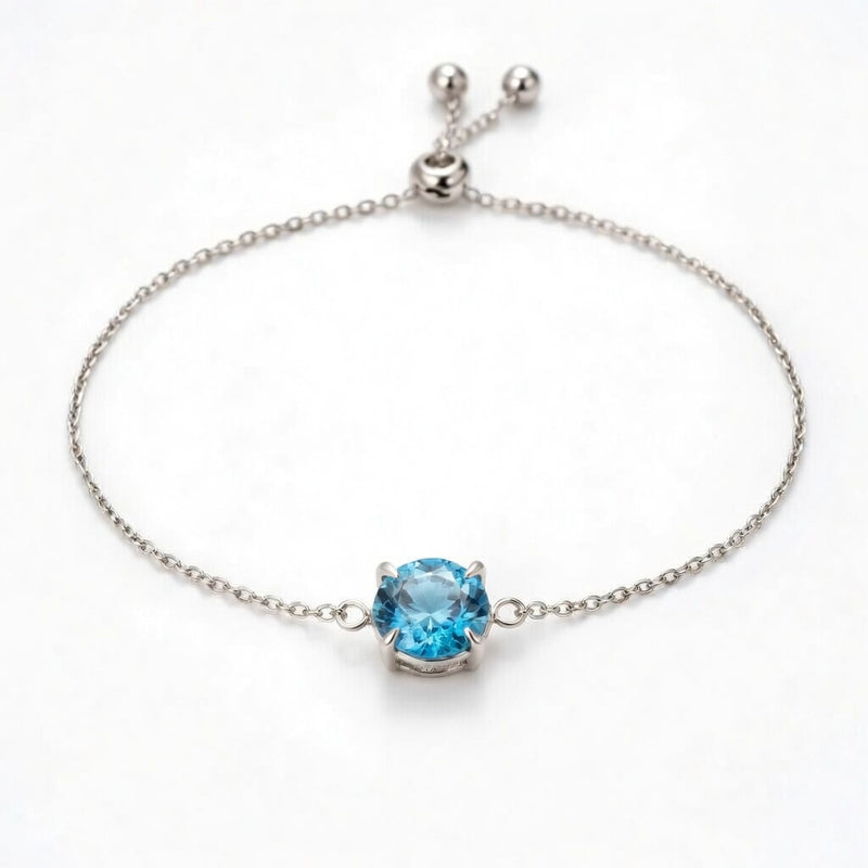blue topaz birthstone bracelet in white gold finish — front view