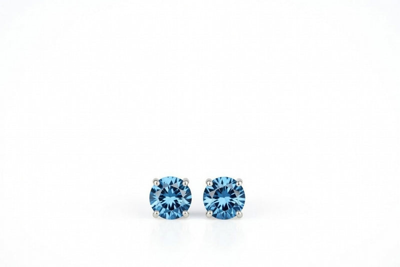 blue topaz birthstone stud earrings in white gold finish — front view