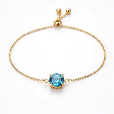 blue topaz birthstone bracelet in yellow gold finish — front view