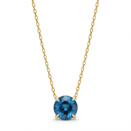 blue topaz birthstone necklace in yellow gold finish — front view