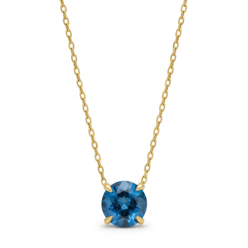 blue topaz birthstone necklace in yellow gold finish — front view