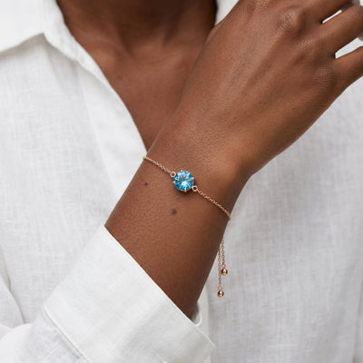 blue topaz birthstone bracelet in rose gold finish — model view