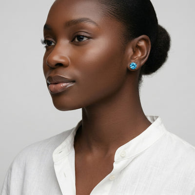blue topaz birthstone stud earrings in rose gold finish — model view