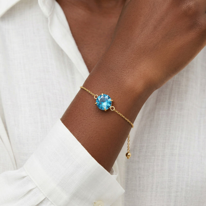blue topaz birthstone bracelet in yellow gold finish — model view
