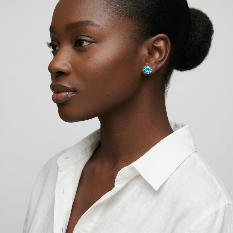 blue topaz birthstone stud earrings in yellow gold finish — model view