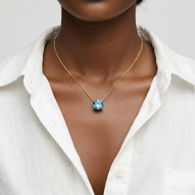 blue topaz birthstone necklace in yellow gold finish — model view