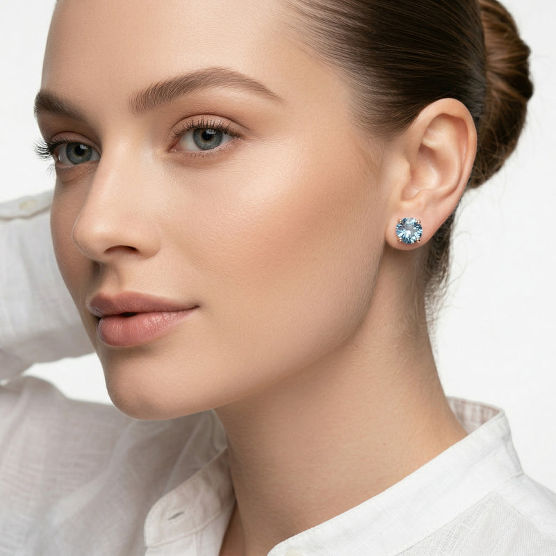 blue topaz birthstone stud earrings in rose gold finish — model view