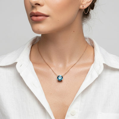 blue topaz birthstone necklace in rose gold finish — model view