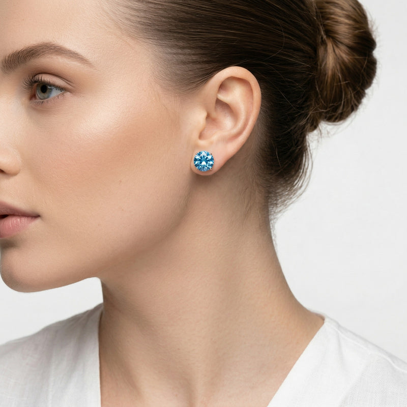 blue topaz birthstone stud earrings in white gold finish — model view