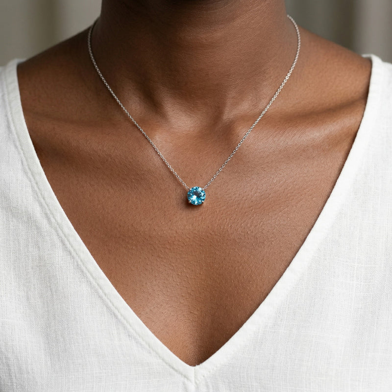 blue topaz birthstone necklace in white gold finish — model view