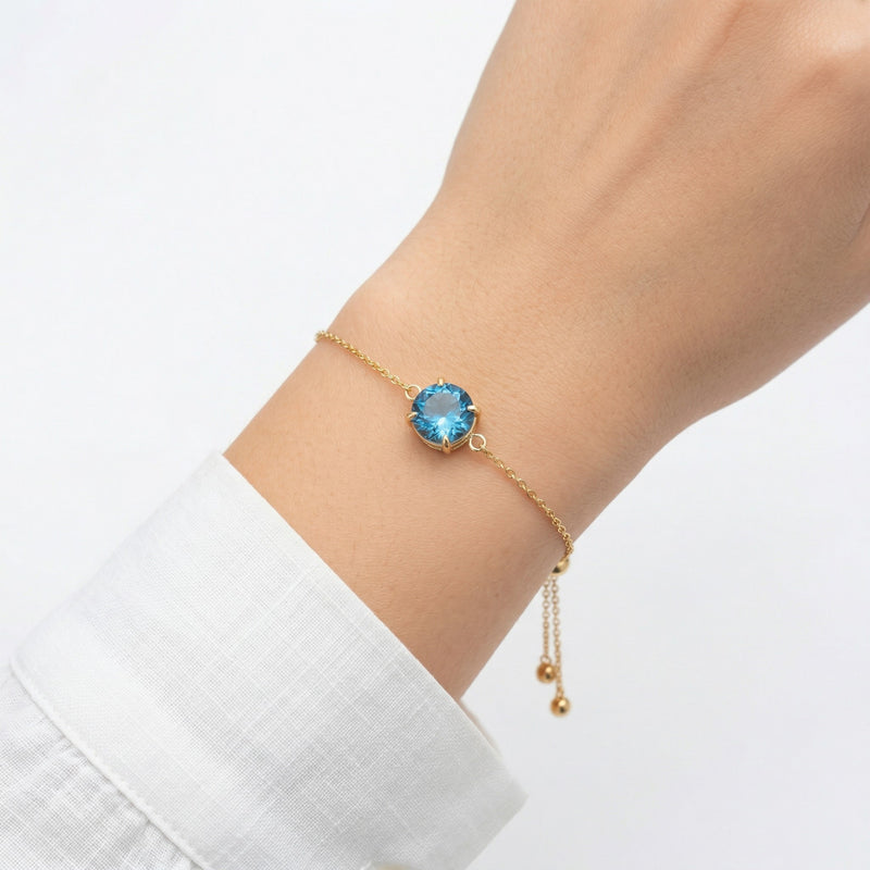 blue topaz birthstone bracelet in yellow gold finish — model view