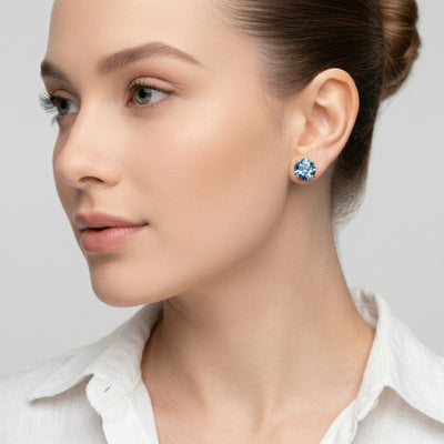 blue topaz birthstone stud earrings in yellow gold finish — model view