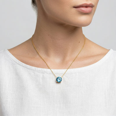 blue topaz birthstone necklace in yellow gold finish — model view