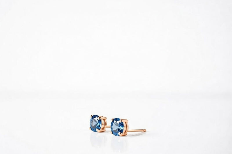 blue topaz birthstone stud earrings in rose gold finish — side view