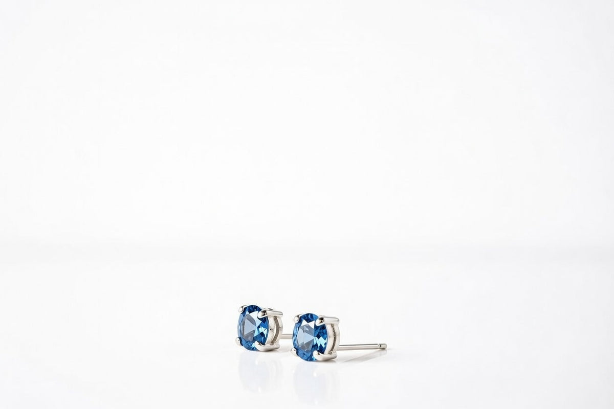 blue topaz birthstone stud earrings in white gold finish — side view