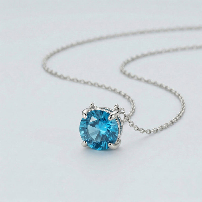 blue topaz birthstone necklace in white gold finish — side view