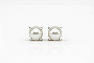pearl birthstone stud earrings in white gold finish — front view
