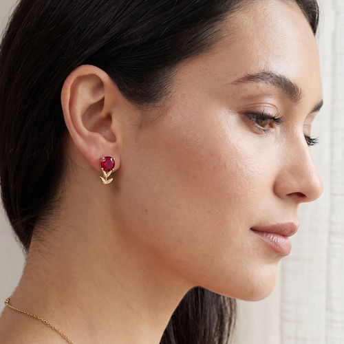 ruby flower stud earrings in yellow gold finish — model view