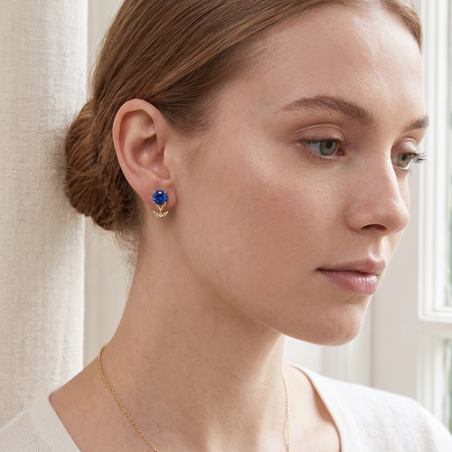 blue sapphire flower stud earrings in yellow gold finish — model view