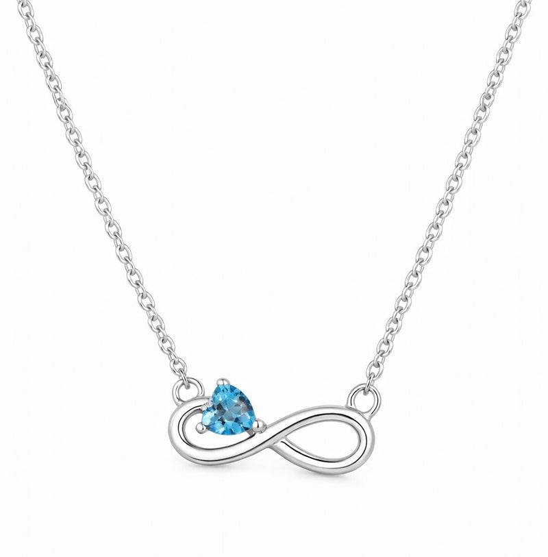 blue topaz birthstone necklace in white gold finish — front view
