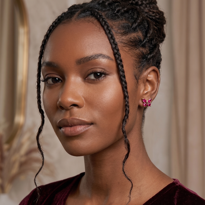 red ruby butterfly stud earrings in yellow gold finish — model view